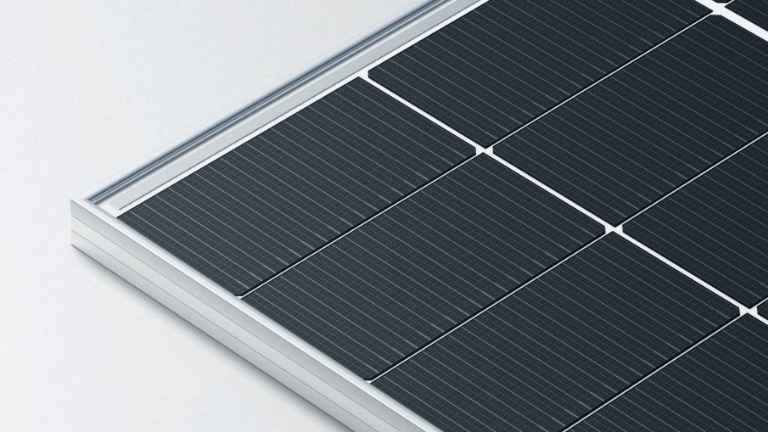 Three solar modules photographed against a dark background