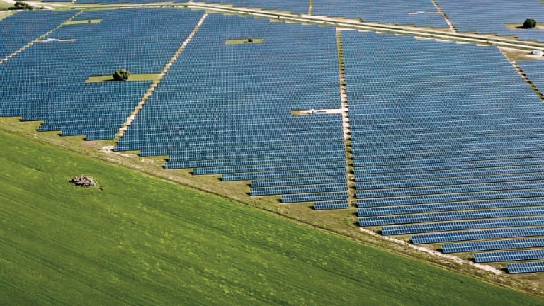 Utility-scale ground-mounted solar array in open countryside
